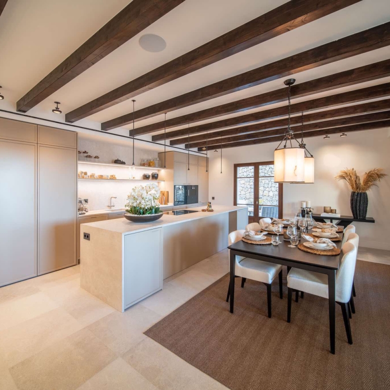 Open-plan living room flooded with natural light and sea views through full-height glazing, luxury villa Cala Llamp, Mallorca